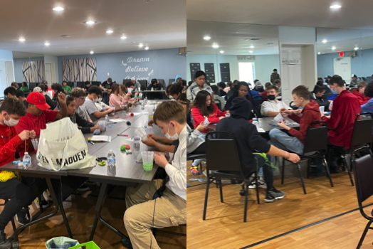 Students drawing at long tables during an EaselArts workshop.